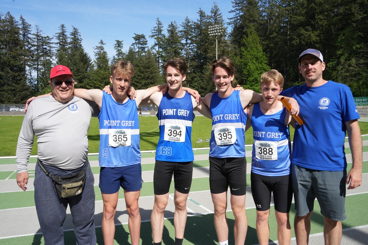 Point Grey athlete running on a blue track